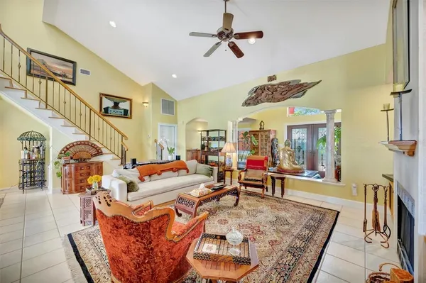 a front view of a dining room with furniture and chandelier