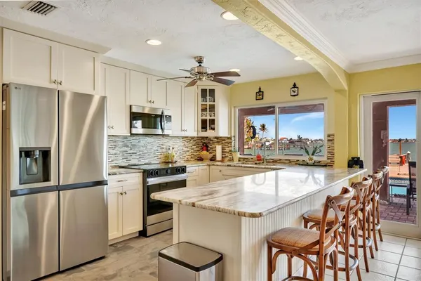 a very nice looking bedroom with a bed a flat screen tv and a dresser