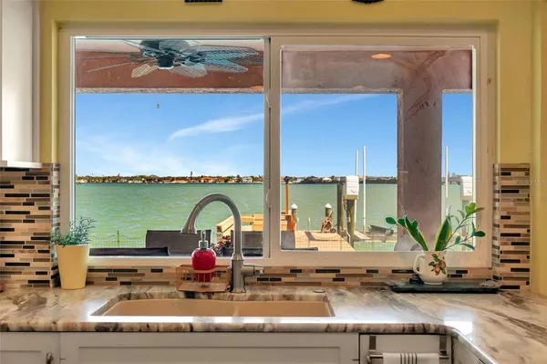 a large bathroom with a granite countertop double vanity sink a bathtub and with shower