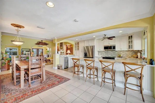 a living room with fireplace furniture and a large window