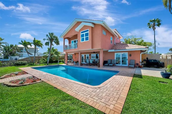 a bedroom with a bed and dresser with wooden floor