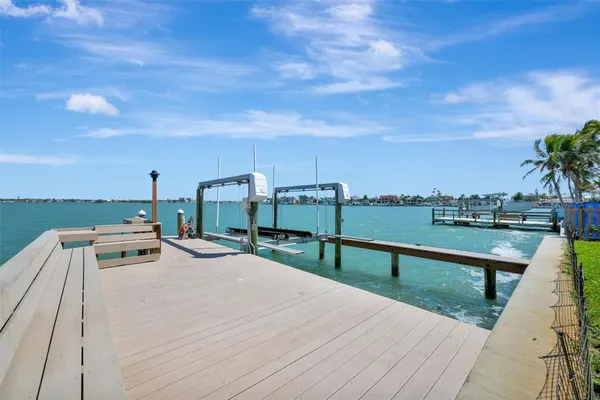 a bathroom with a granite countertop toilet sink and mirror
