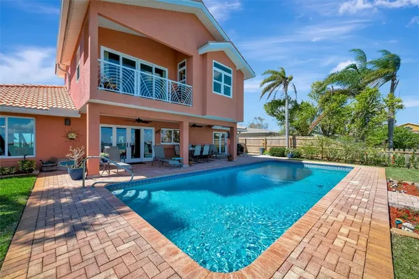 a living room with furniture a rug and a book shelf