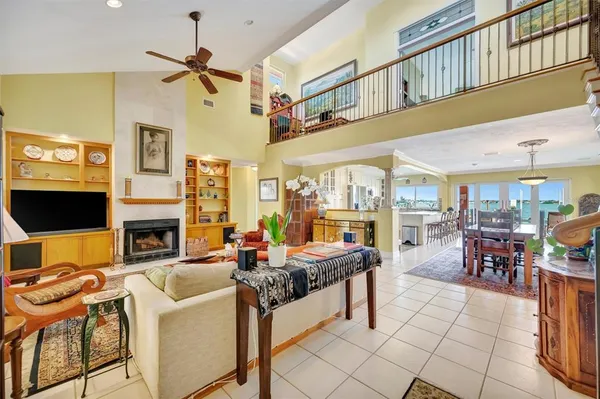 a living room with patio furniture and a rug