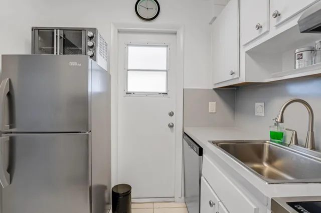 a kitchen with stainless steel appliances granite countertop a refrigerator sink and cabinets