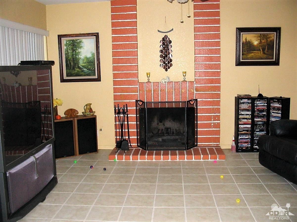23680 Blooming Meadow Road Moreno Valley, CA 92557 - Photo 5 of 22 a living room with furniture a flat screen tv and a fireplace