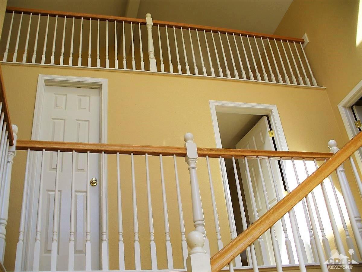 23680 Blooming Meadow Road Moreno Valley, CA 92557 - Photo 6 of 22 a view of staircase with railing and white walls