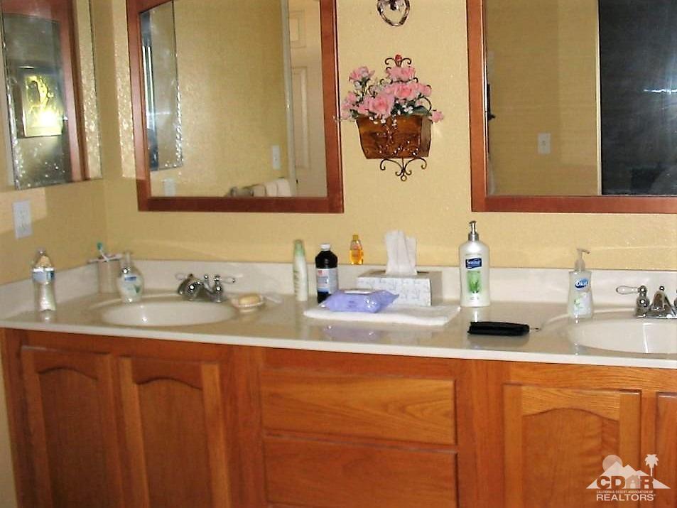 23680 Blooming Meadow Road Moreno Valley, CA 92557 - Photo 9 of 22 a bathroom with a sink double vanity and a mirror