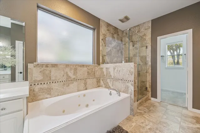 a bathroom with a bathtub and shower