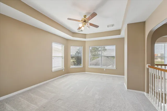 a view of a livingroom with a ceiling fan and window