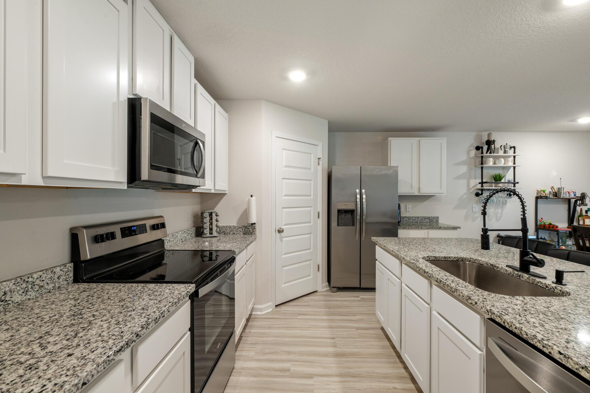 810 Otto Loop Crestview, FL 32539 - Photo 14 of 41 a kitchen with stainless steel appliances granite countertop a sink stove and refrigerator