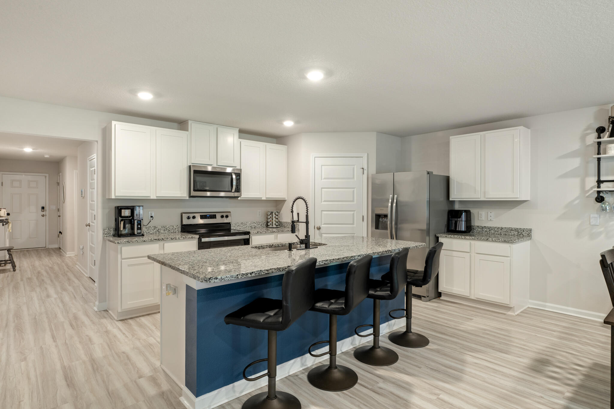 810 Otto Loop Crestview, FL 32539 - Photo 17 of 41 a kitchen with stainless steel appliances granite countertop a table chairs sink refrigerator and cabinets