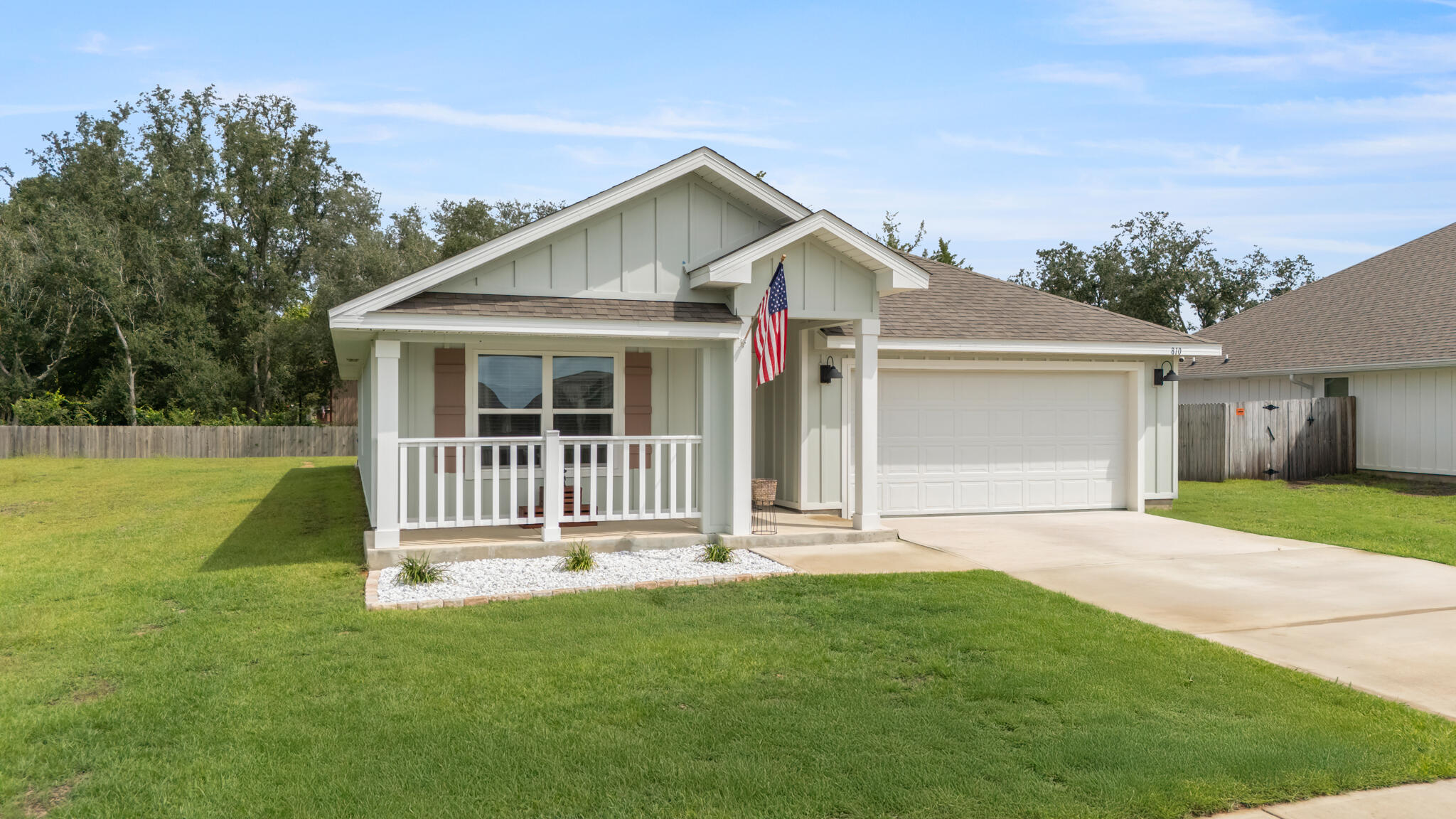 810 Otto Loop Crestview, FL 32539 - Photo 2 of 41 a front view of a house with a garden and yard