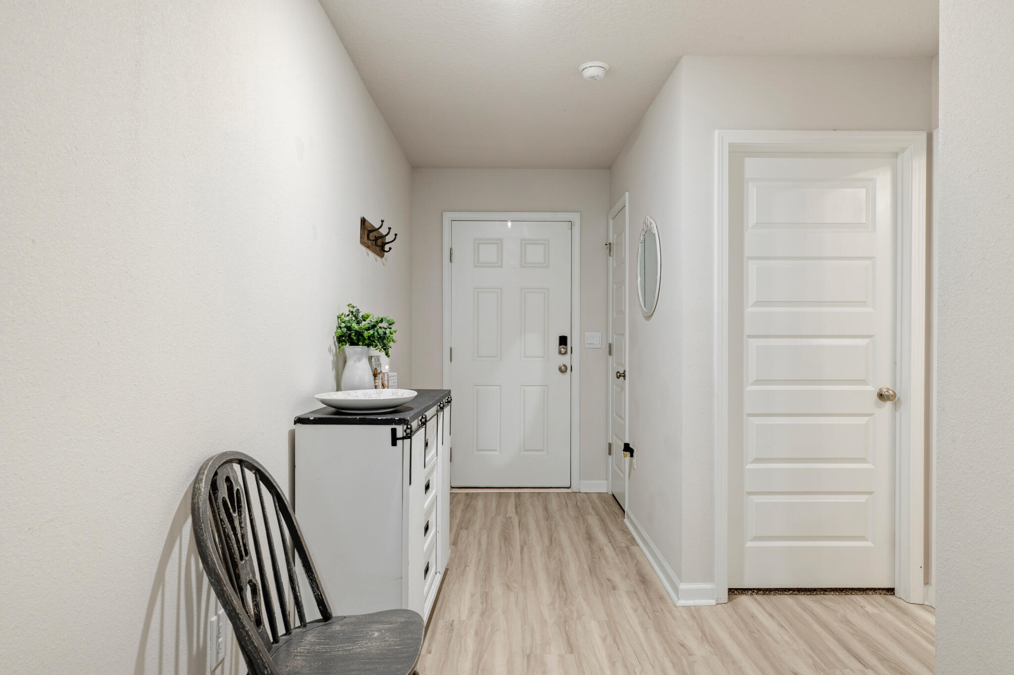 810 Otto Loop Crestview, FL 32539 - Photo 4 of 41 a view of a hallway with wooden floor and stairs