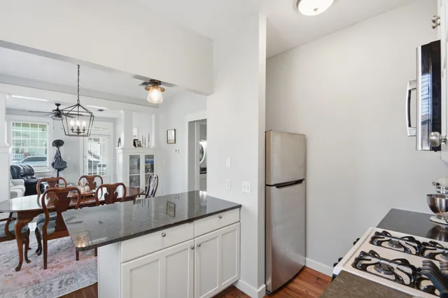 a very nice looking room with a dining table and a refrigerator
