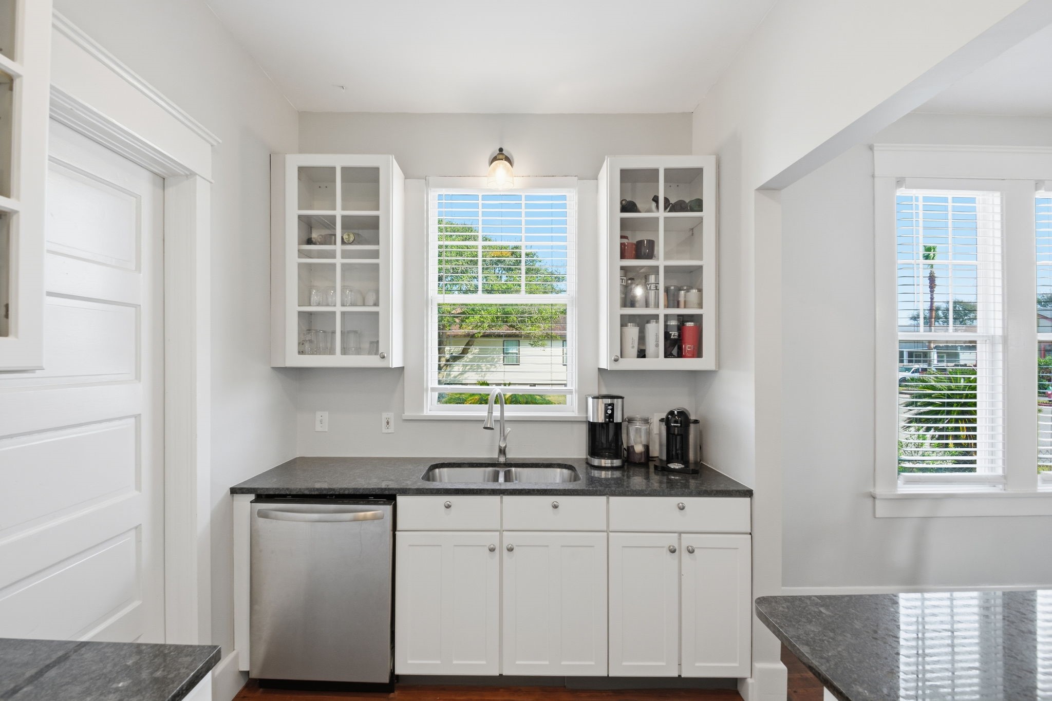 3602 Avenue R Galveston, TX 77550 - Photo 12 of 25 a kitchen with granite countertop a sink and a window