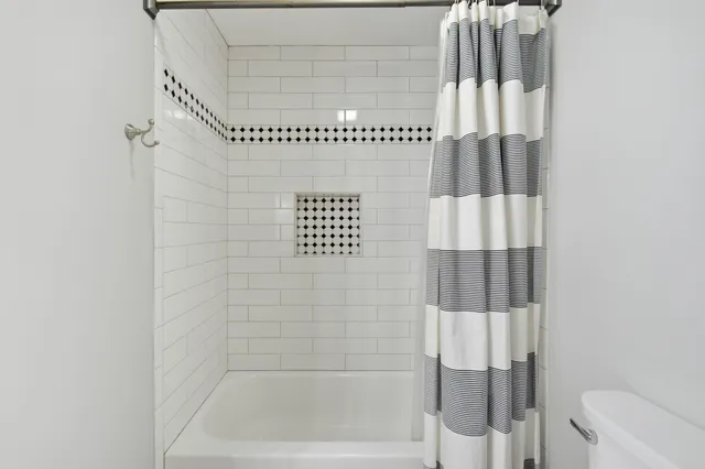 a bathroom with a shower and a bathtub
