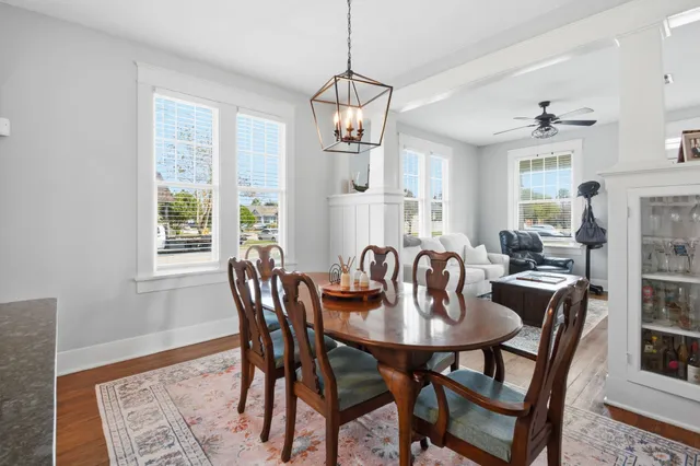a dining room with furniture a chandelier and window