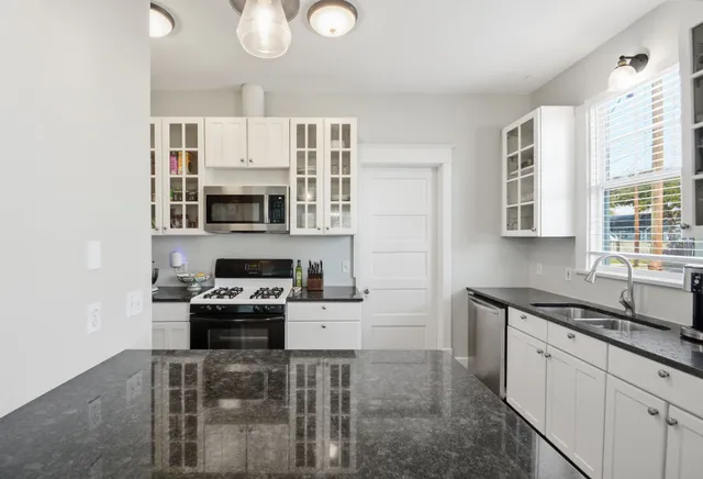 a kitchen with cabinets and stainless steel appliances