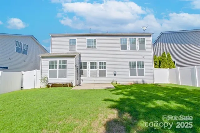 a view of a house with a yard and sitting area