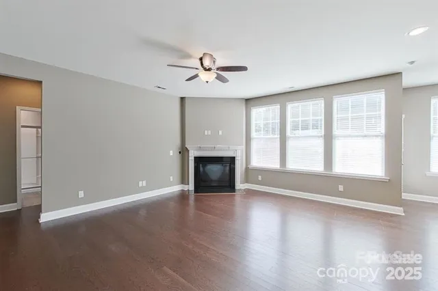 wooden floor chandelier and windows in a room