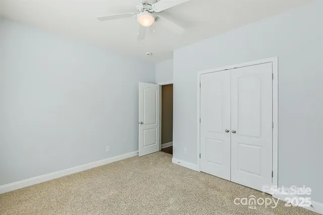 an empty room with a ceiling fan