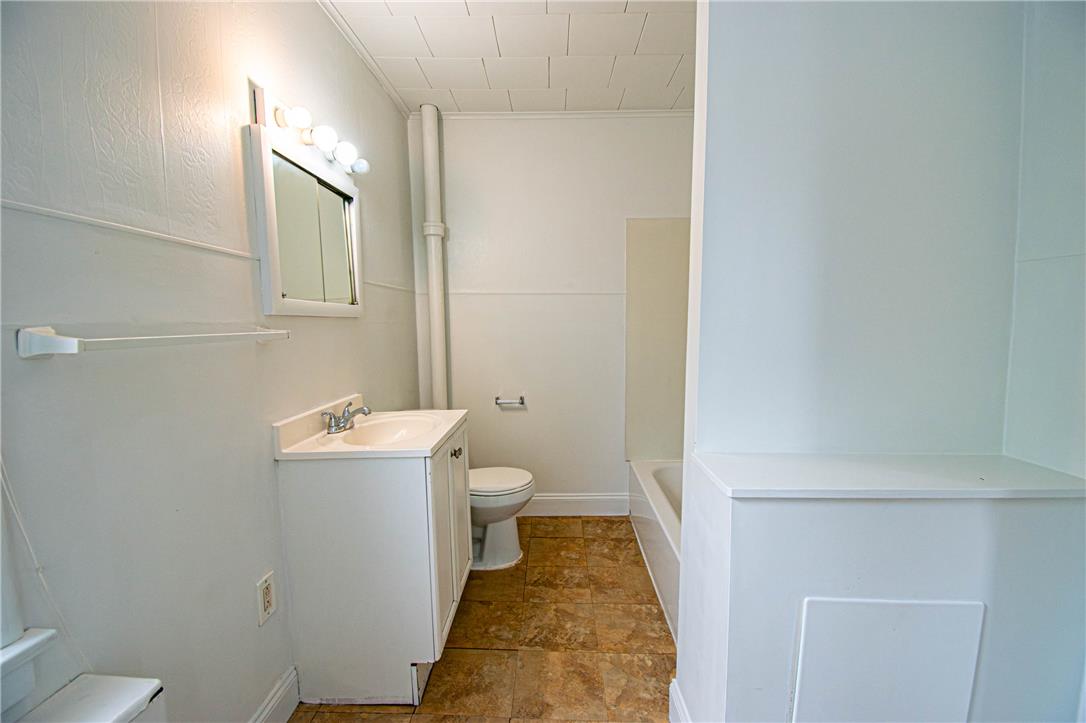 27 West Allen Street Allentown, PA 18102 - Photo 18 of 26 Functional bathroom features a sink vanity, a toilet, and a bathtub with a tiled floor.