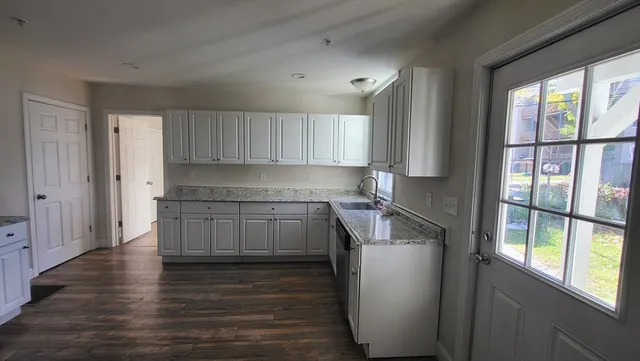 a kitchen with a refrigerator and window