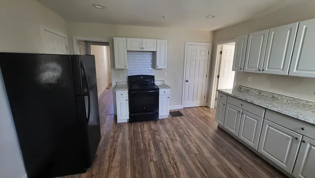 a kitchen with a refrigerator and a sink
