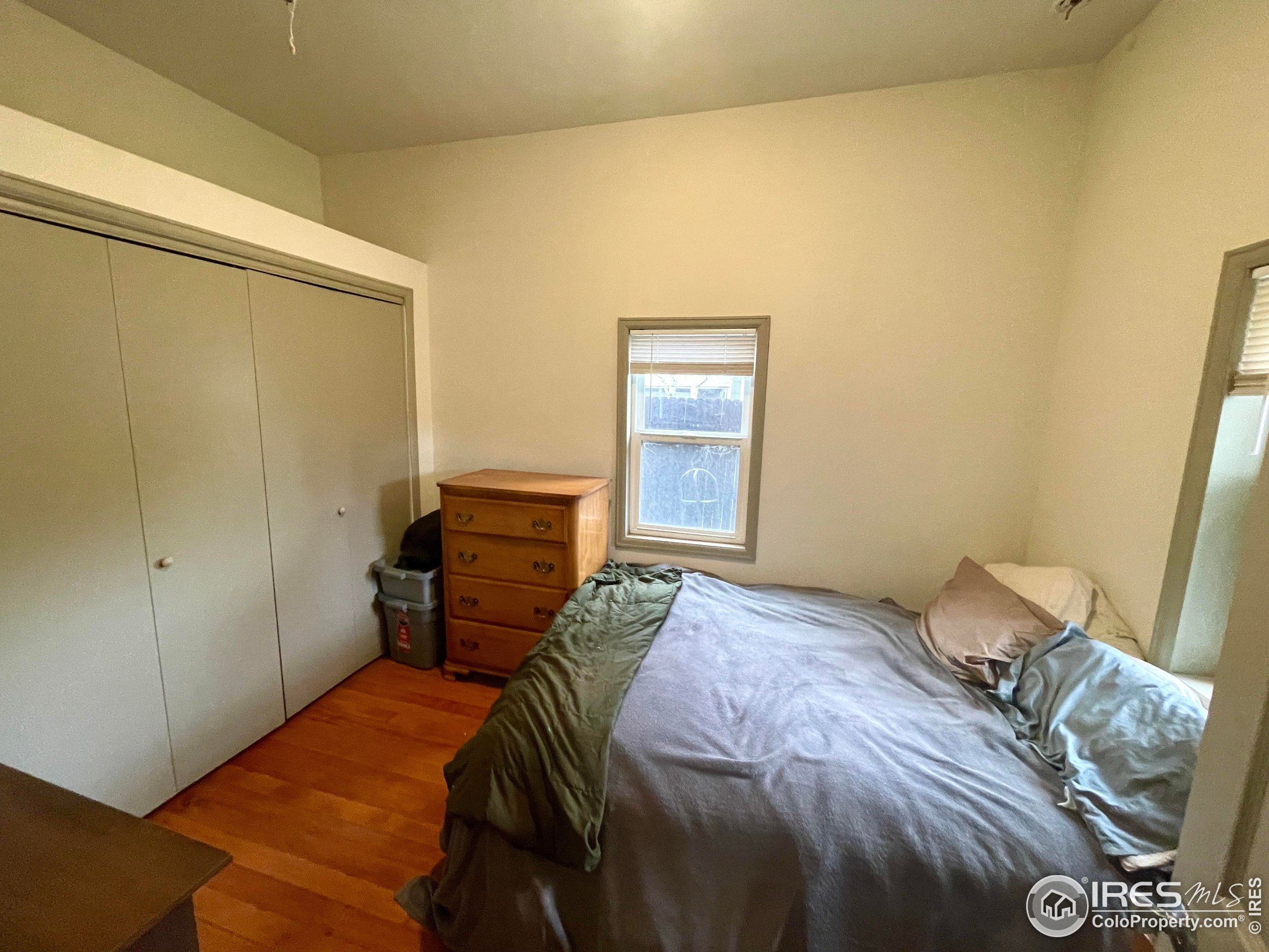 470 West Spring Street Nederland, CO 80466 - Photo 11 of 19 a bedroom with a bed and wooden floor