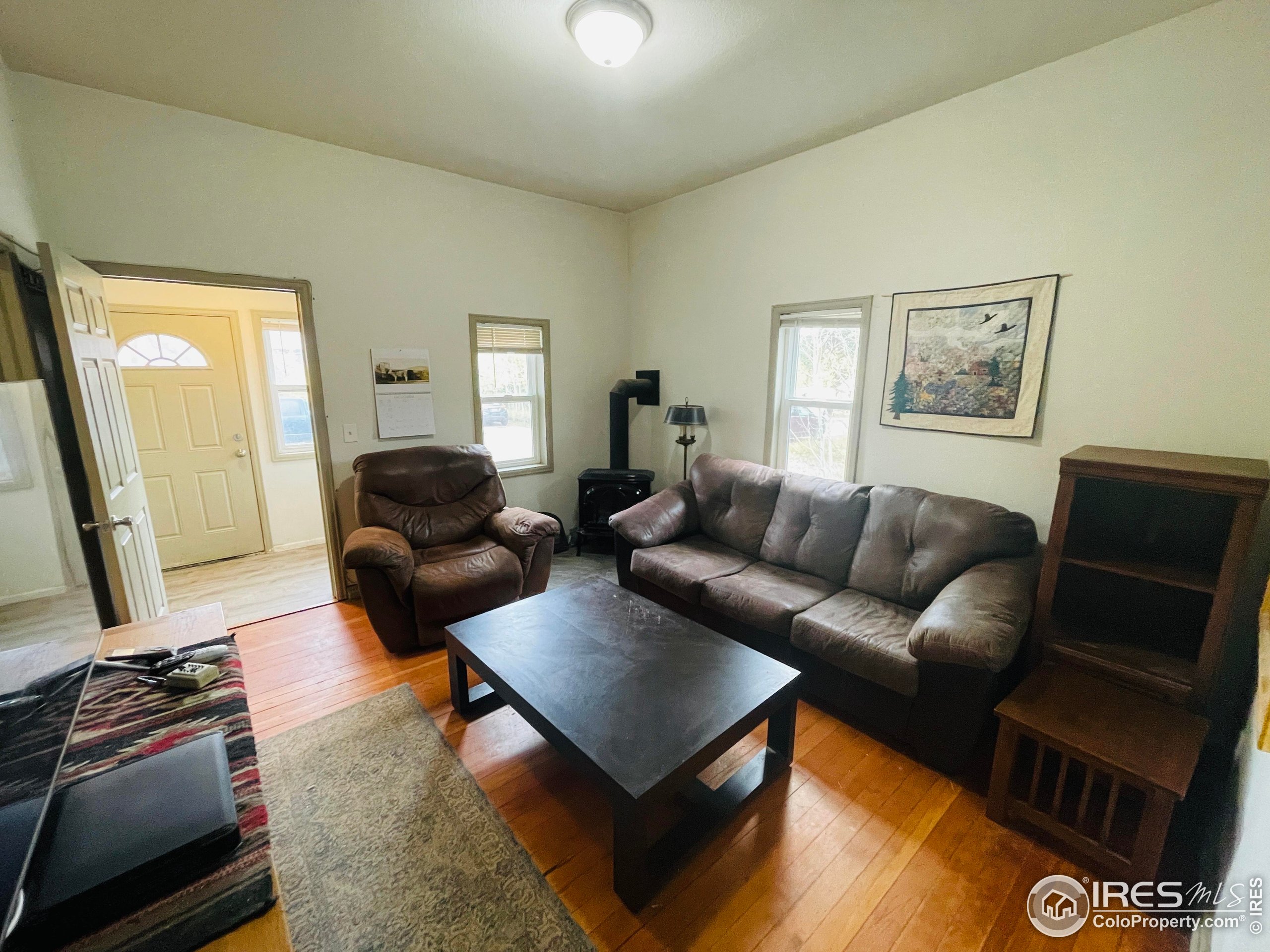 470 West Spring Street Nederland, CO 80466 - Photo 4 of 19 a living room with furniture and a flat screen tv