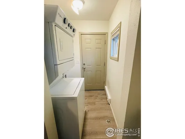 a bedroom with a bed and a flat tv screen on the dresser