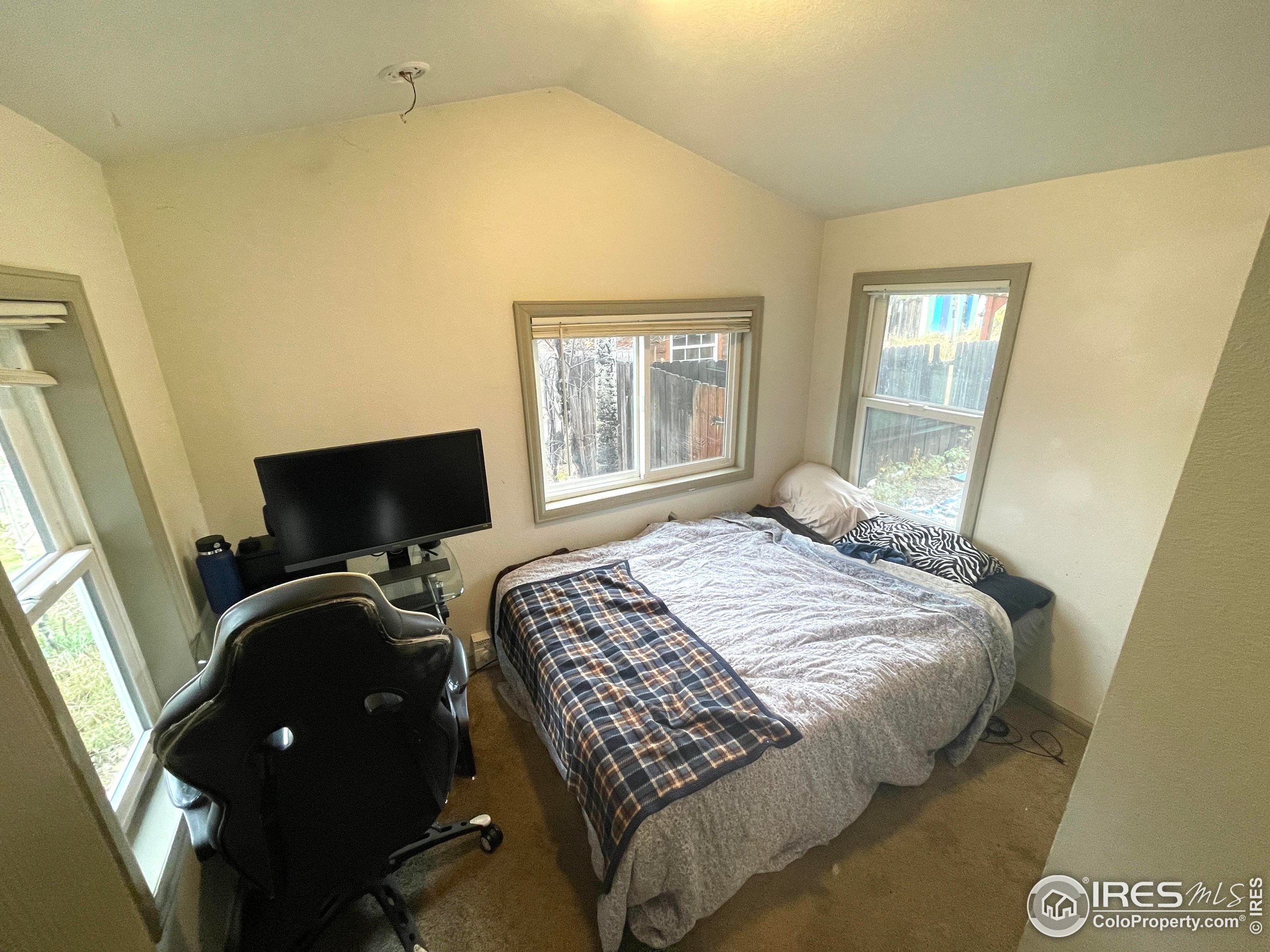 470 West Spring Street Nederland, CO 80466 - Photo 9 of 19 a bedroom with a bed and a flat tv screen on the dresser