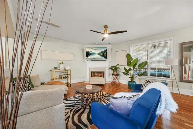 a living room with furniture fireplace and a flat screen tv