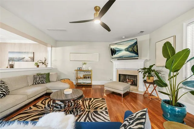 a living room with furniture a fireplace and a flat screen tv