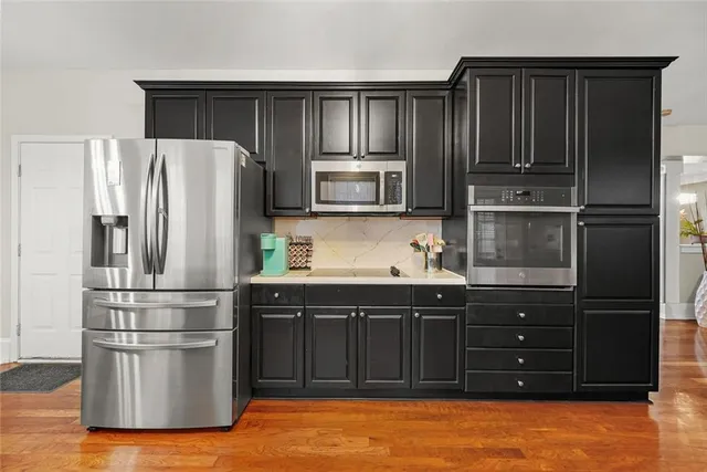 a kitchen with granite countertop wooden cabinets and stainless steel appliances