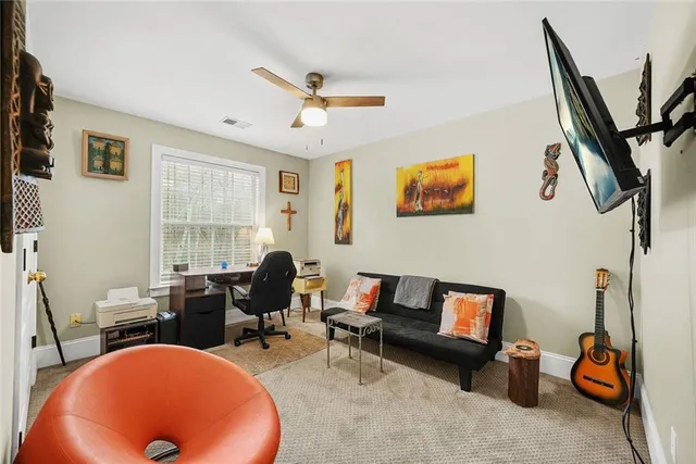 a bedroom with a bed and a ceiling fan