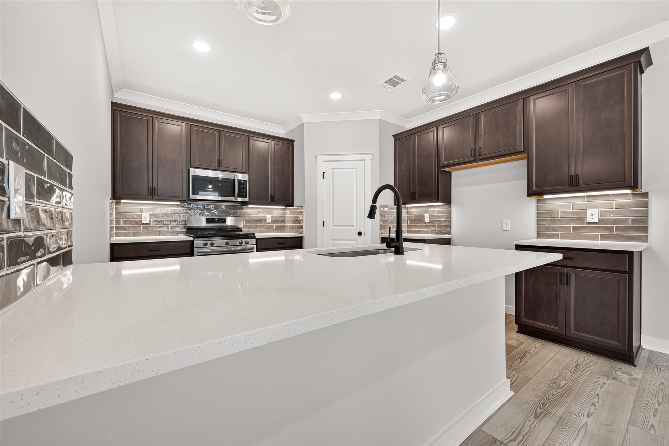 21122 Autumn Heights Rosharon, TX 77583 - Photo 14 of 42 a kitchen with stainless steel appliances a sink stove refrigerator and cabinets