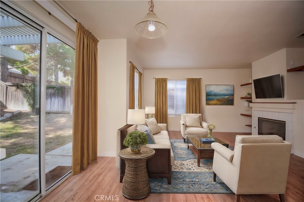 554 Pointe Vista Court Corona, CA 92881 - Photo 13 of 31 a living room with furniture a fireplace and a floor to ceiling window