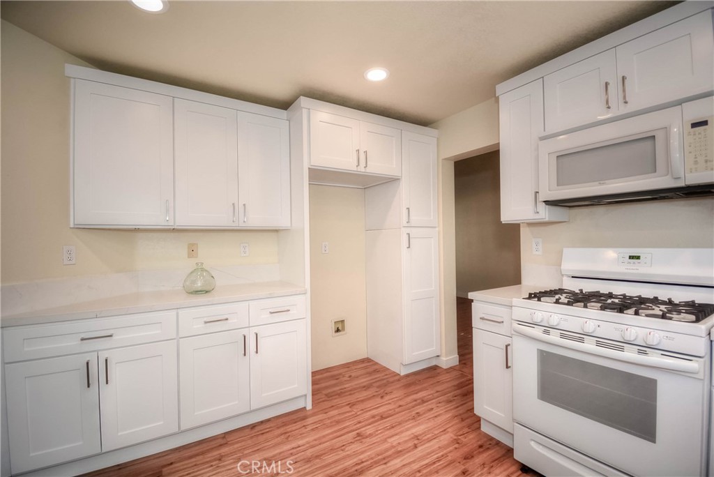 554 Pointe Vista Court Corona, CA 92881 - Photo 15 of 31 a kitchen with white cabinets and appliances