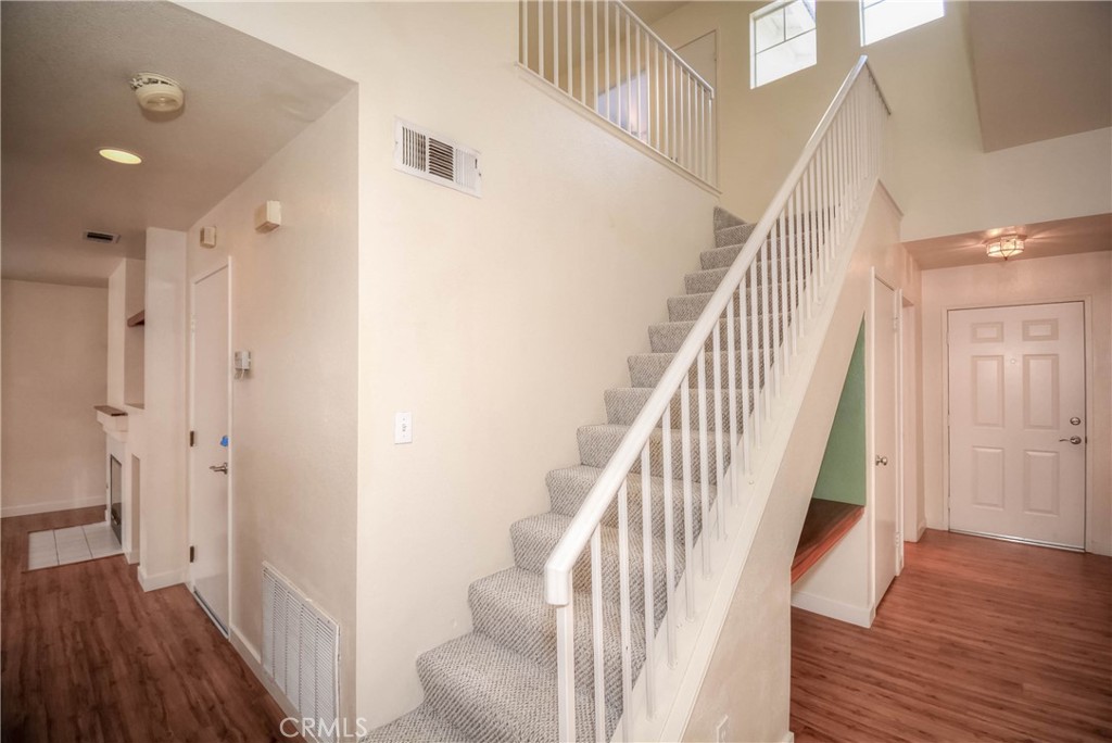 554 Pointe Vista Court Corona, CA 92881 - Photo 16 of 31 a view of staircase with wooden floor and white walls