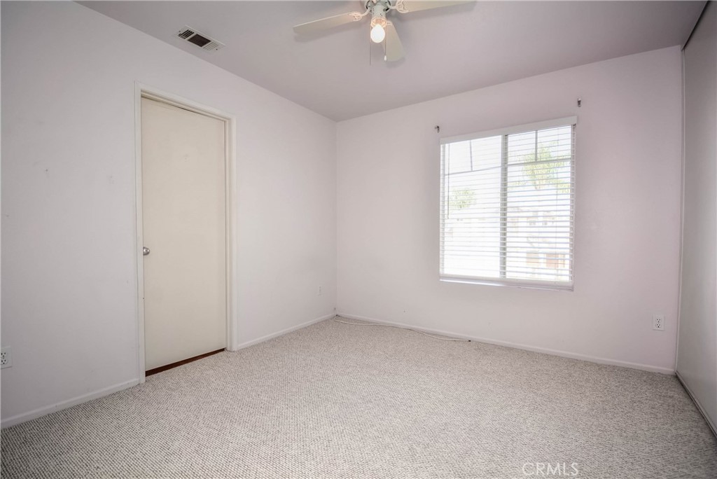 554 Pointe Vista Court Corona, CA 92881 - Photo 23 of 31 an empty room with a window and a ceiling fan