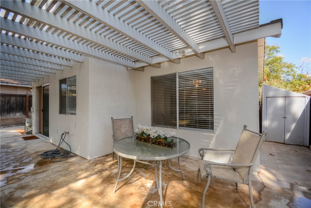 554 Pointe Vista Court Corona, CA 92881 - Photo 27 of 31 a patio with a table and chairs and potted plants