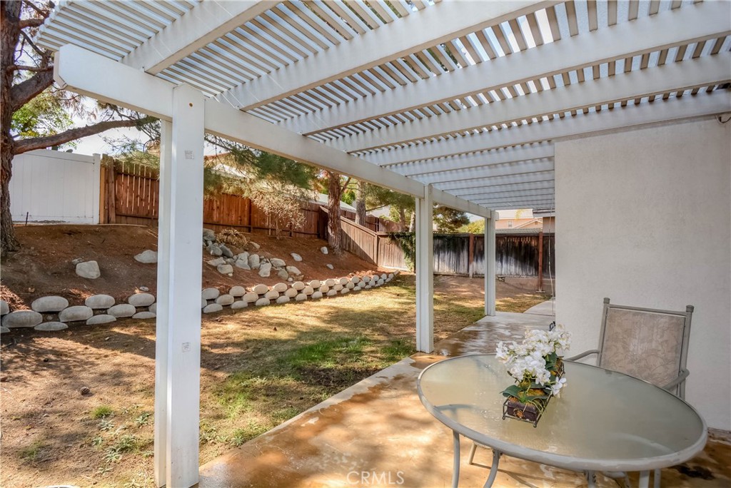 554 Pointe Vista Court Corona, CA 92881 - Photo 28 of 31 a patio with table and chairs and potted plants