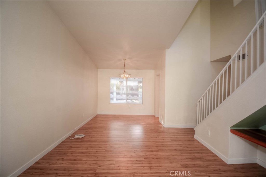 554 Pointe Vista Court Corona, CA 92881 - Photo 5 of 31 a view of an empty room with wooden floor and a window