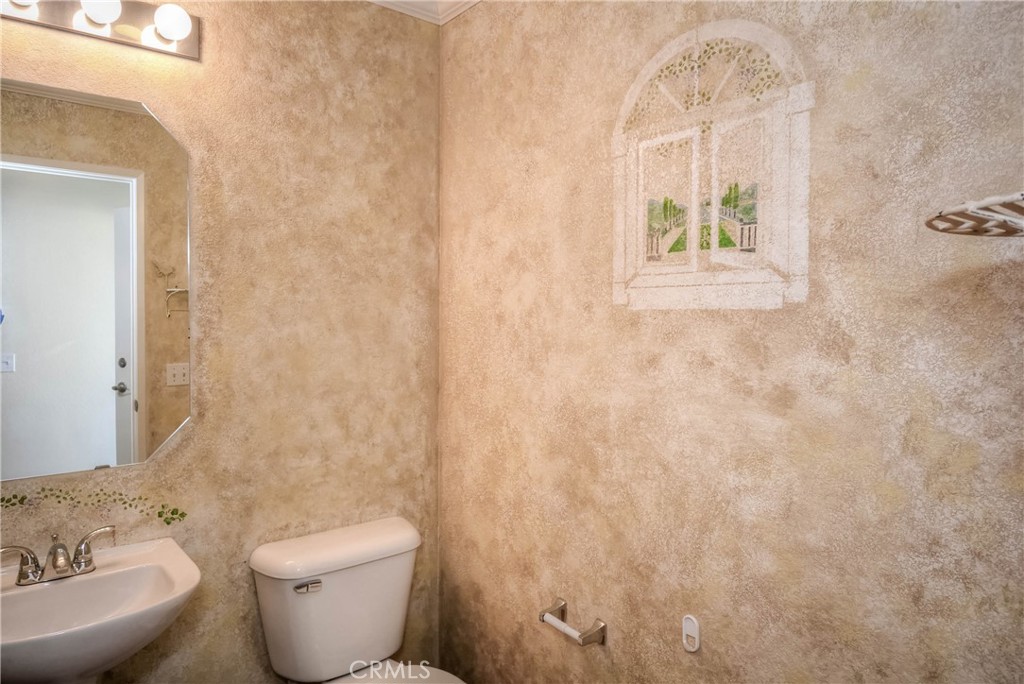 554 Pointe Vista Court Corona, CA 92881 - Photo 8 of 31 a white toilet sitting next to a bathroom sink