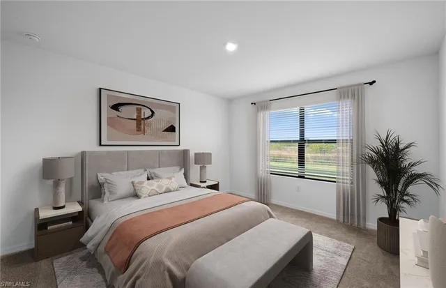 a bedroom with a large bed and a window