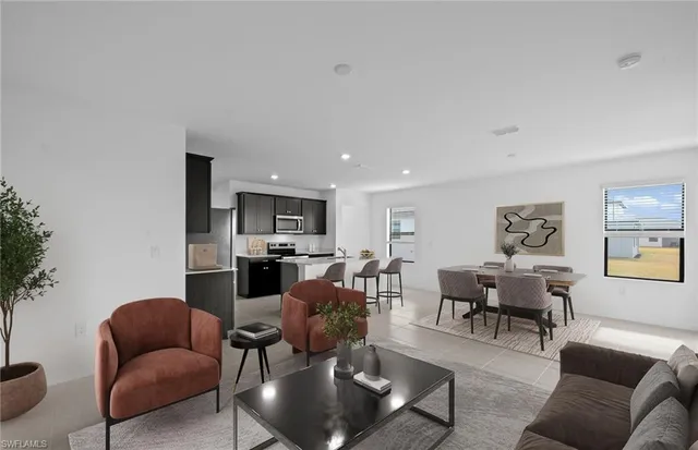 a living room with furniture kitchen view and a potted plant