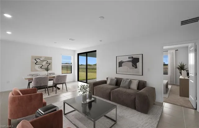 a living room with furniture potted plant and a window