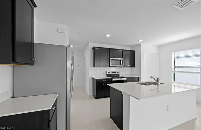 a kitchen that has a sink and a stove in it